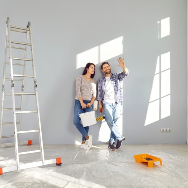 Young,Family,Couple,Doing,Renovations,At,Home.,Happy,Man,And